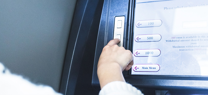 Woman using cash machine-ATM,close up view