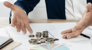close-up-man-with-coins-statistics-850