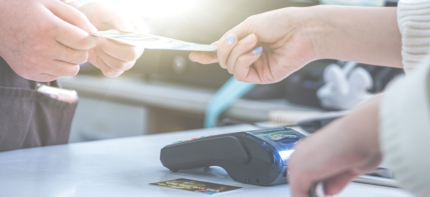 cash and card payment with chip and pin machine in shop